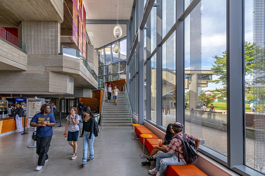 Students walking and studying in library.